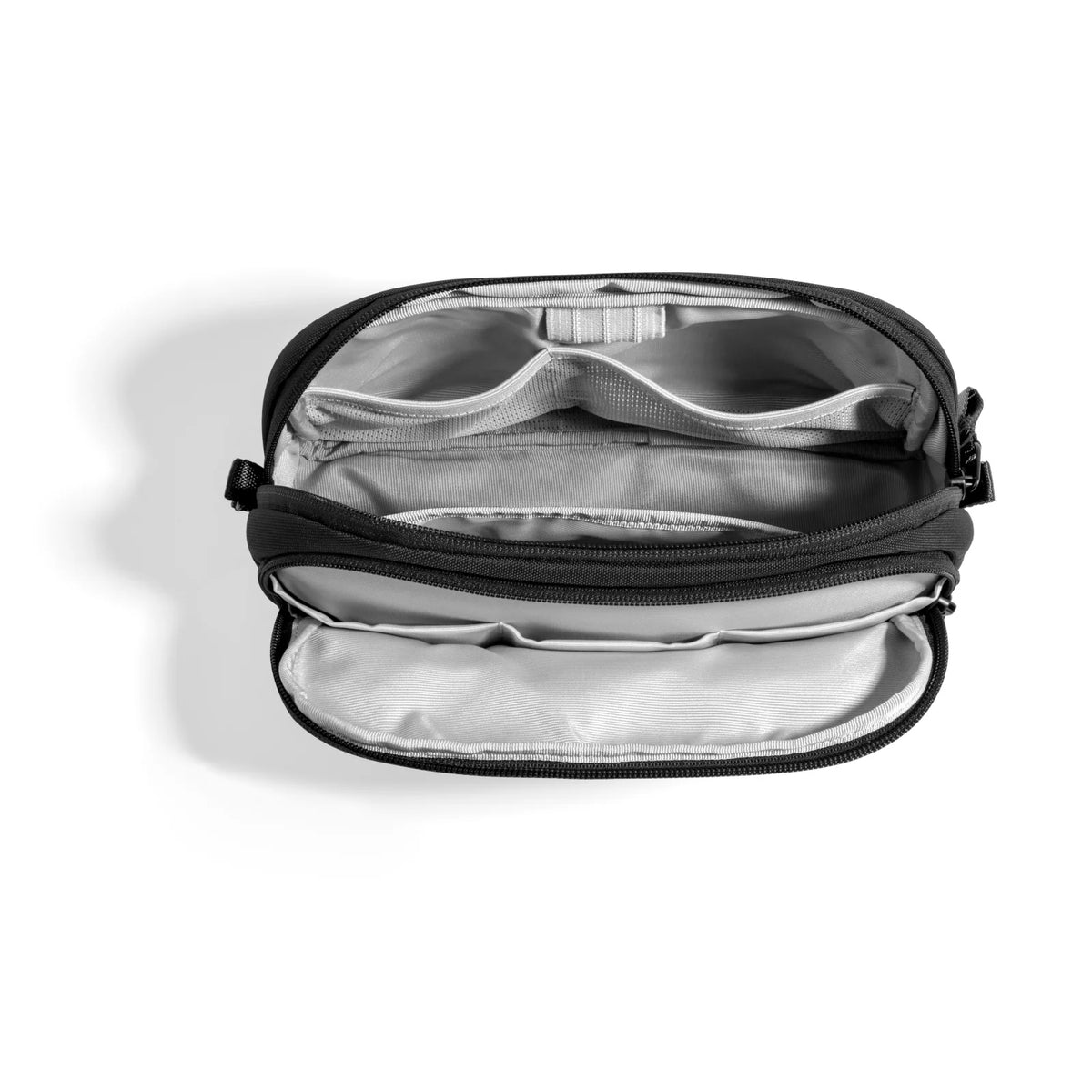 Black travel pouch with silver interior on a white background