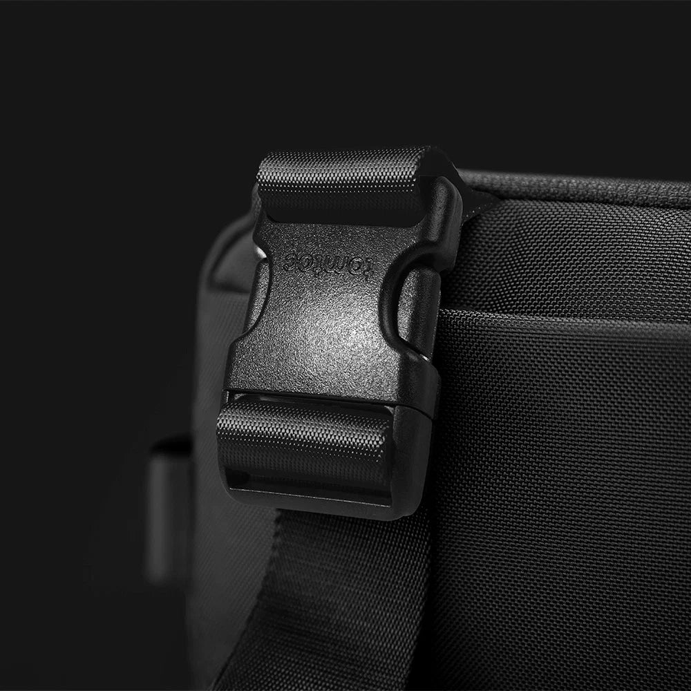 Close-up of a Black shoulder bag T21L1D1 tomtoc Business Laptop Sling Bag with a buckle on a dark background