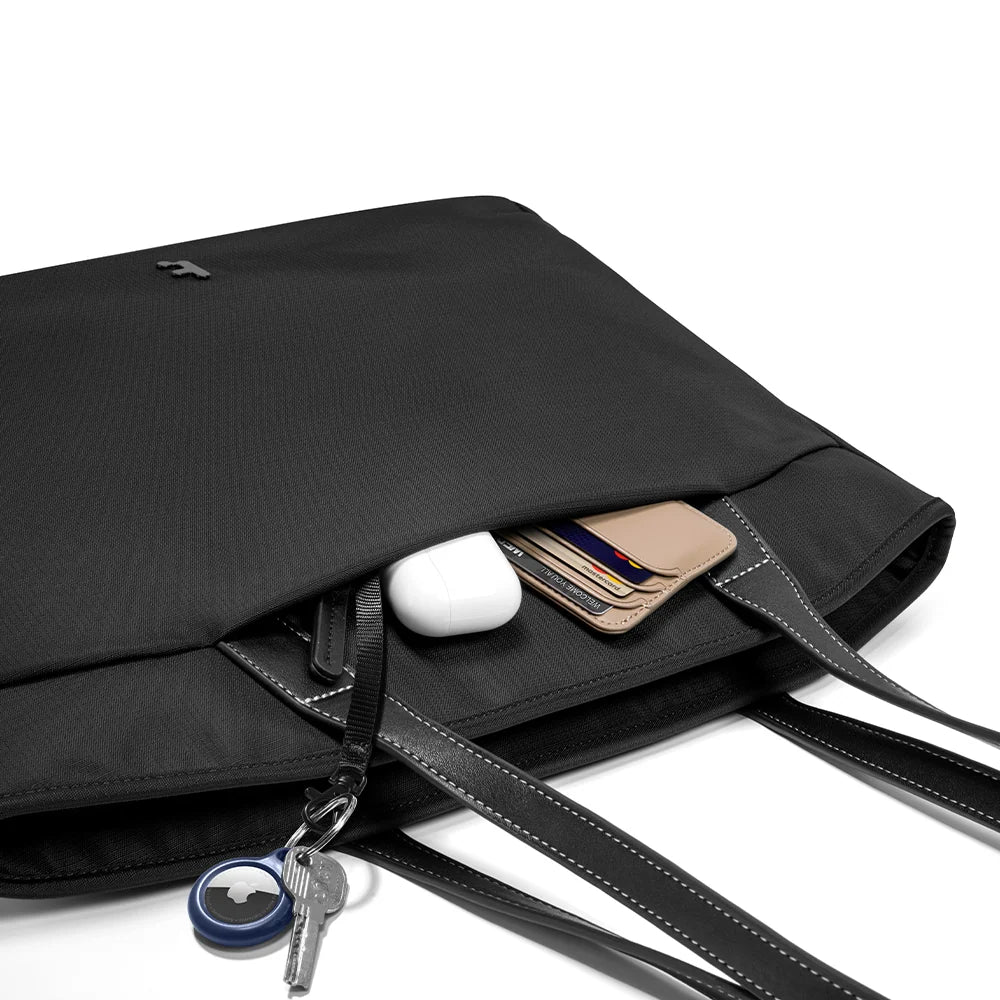 A black tote bag T23S1D1 tomtoc versatile laptop tote bag small with dual shoulder straps and a small tomtoc logo at the bottom center, shown against a plain white background