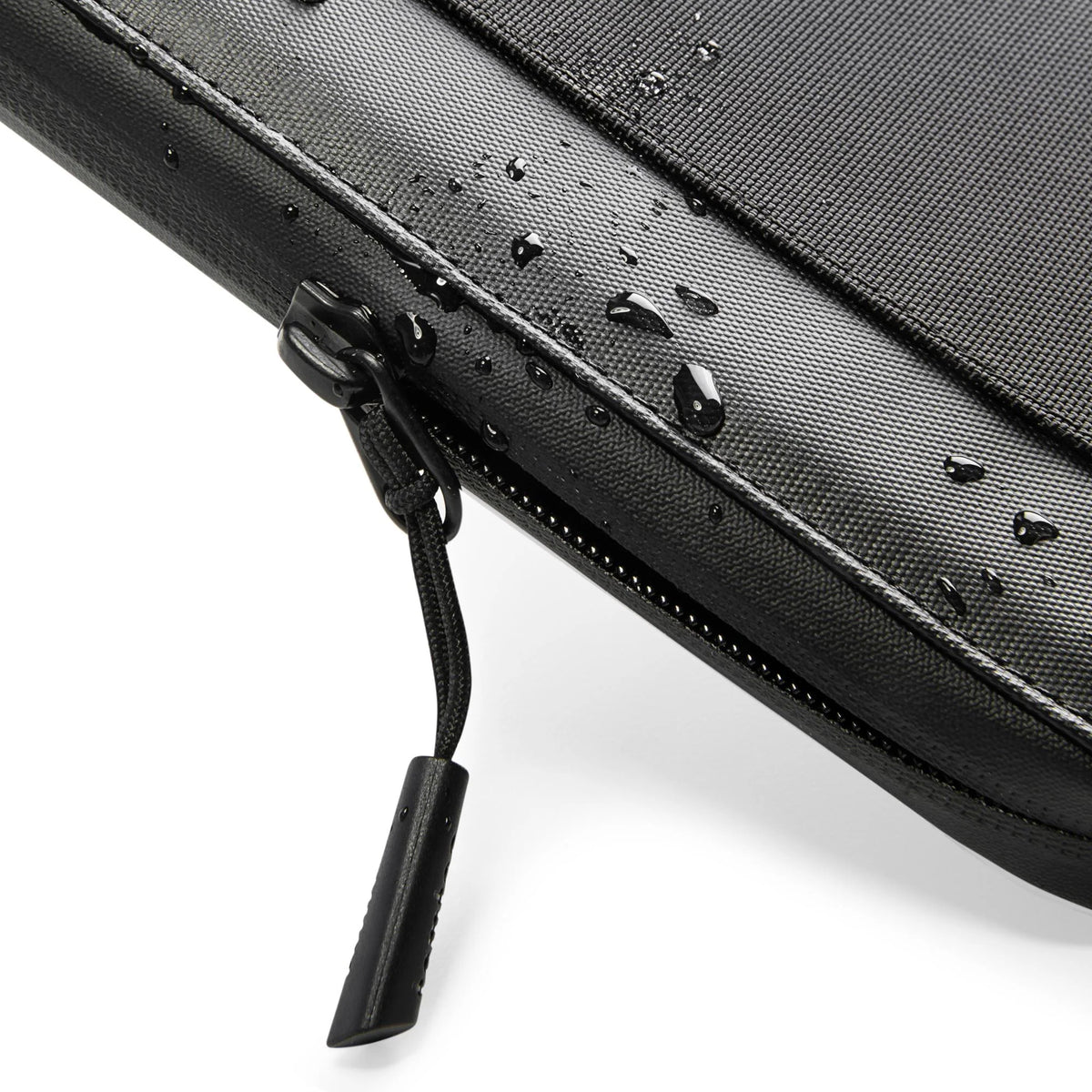 tomtoc T03 Navigator Passport Wallet black detail with water droplets on a white background