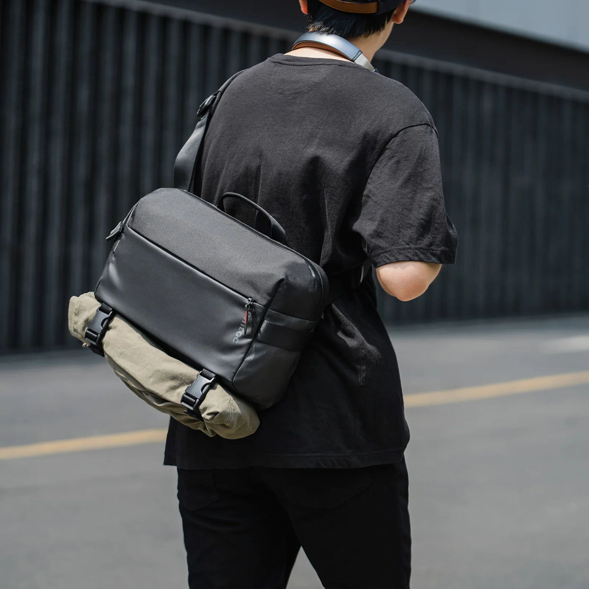 Person wearing a tomtoc T21L1D1 Business laptop sling bag on street