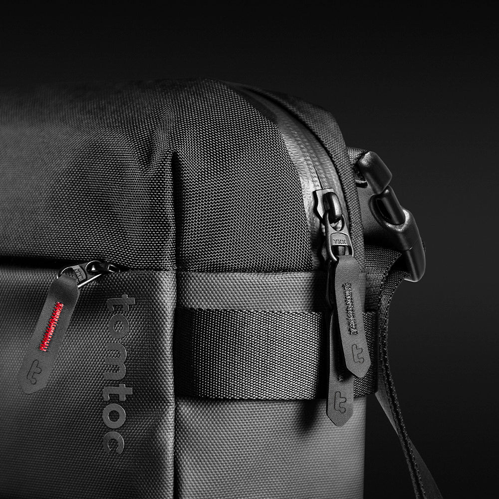 Close-up of Black shoulder bag T21L1D1 tomtoc Business Laptop Sling Bag with a visible brand logo