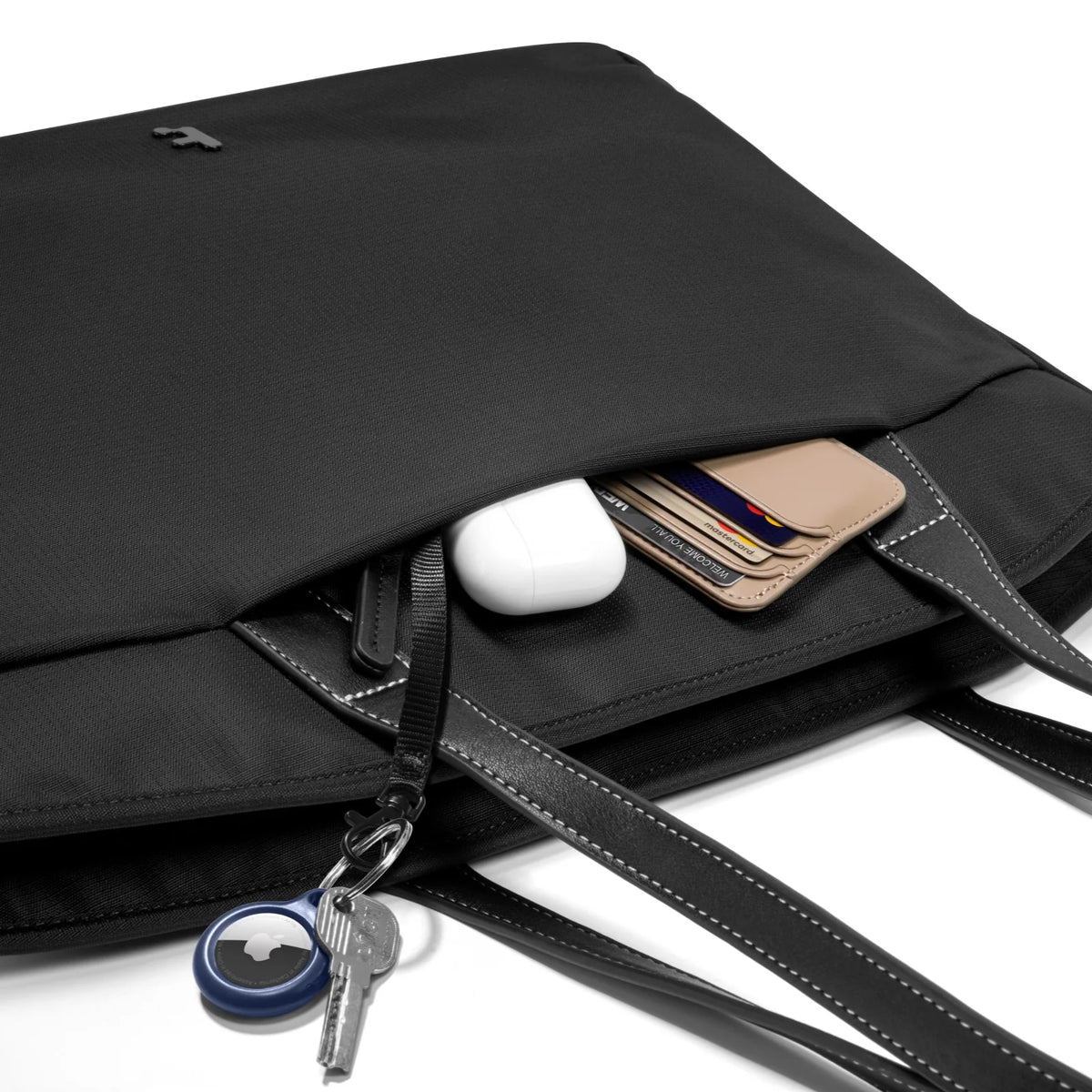 A black tote bag T23L1D1 tomtoc versatile laptop tote bag small with dual shoulder straps and a small tomtoc logo at the bottom center, shown against a plain white background